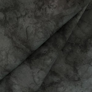 May include: Close-up of a dark gray fabric with a marbled pattern. The fabric has a soft, textured surface.
