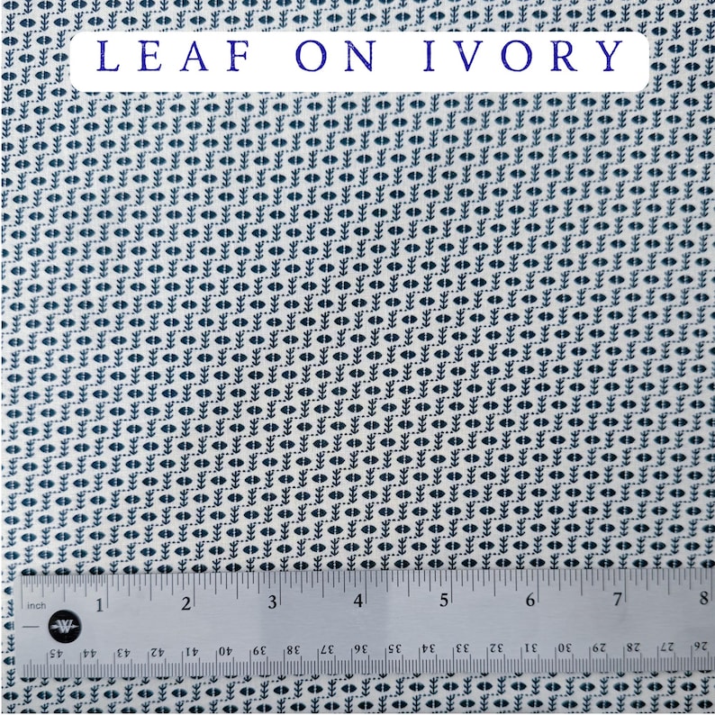 May include: Ivory fabric with a repeating pattern of dark blue leaf-like shapes. The text "LEAF ON IVORY" is displayed in a white rectangle at the top. A ruler is at the bottom, showing measurements in inches.