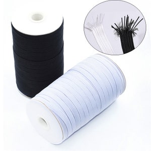 May include: Spools of black and white elastic cord. The elastic is tightly wound around white cardboard cores. A close-up shows the ends of the elastic, revealing the individual strands. Ideal for sewing and crafting projects.