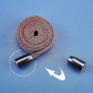 May include: A red and white braided cord with black plastic end caps. The cord is coiled and the end caps are visible.