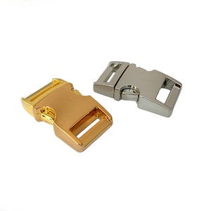 May include: Two metal clasps, one gold and one silver, for attaching to a strap or leash.