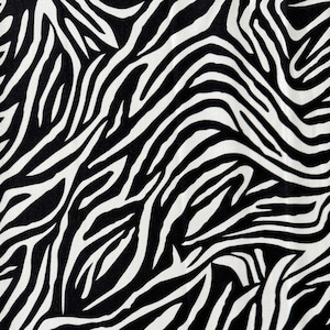 Tessuto di cotone con stampa zebrata, ideale per quilting, abbigliamento e lavori creativi.