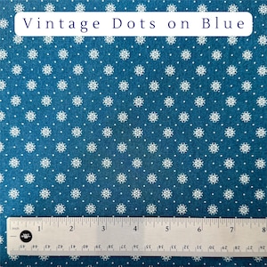 May include: Blue fabric with a repeating pattern of white floral shapes and dots. The text "Vintage Dots on Blue" is displayed at the top. A ruler is at the bottom, marked in inches.