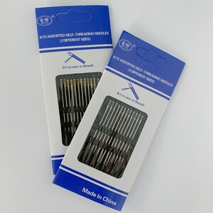 May include: Two packages of 6/12 assorted self-threading needles in three different sizes. The packages are blue and white with the text "6/12 assorted self-threading needles (3 different sizes)" and "It's so easy to thread!" The packages are made in China.