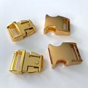 May include: Four gold-colored plastic side release buckles. The buckles are commonly used for dog collars, leashes, and other pet accessories.