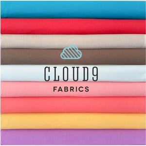 May include: A stack of colourful fabric swatches in various shades of blue, red, beige, brown, pink, orange, yellow, and purple. The fabric swatches are arranged in a vertical stack. The text "CLOUD9 FABRICS" is printed in black on a white background.