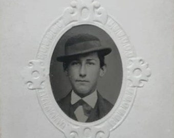 GEM tintype in carte de visite size cartouche sleeve young man in hat 1860s photo