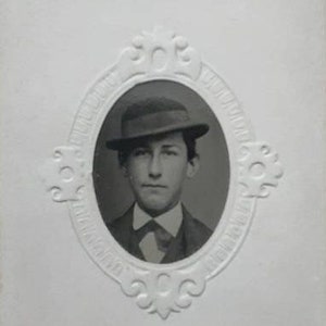 GEM tintype in carte de visite size cartouche sleeve young man in hat 1860s photo