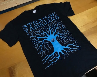 STRANGE FAMILIARS podcast Awoken Tree logo t-shirt paranormal Fortean cryptids
