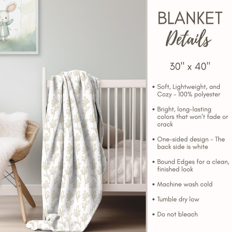 a white crib with a blanket draped over it, and there is a picture of a rabbit on the wall.