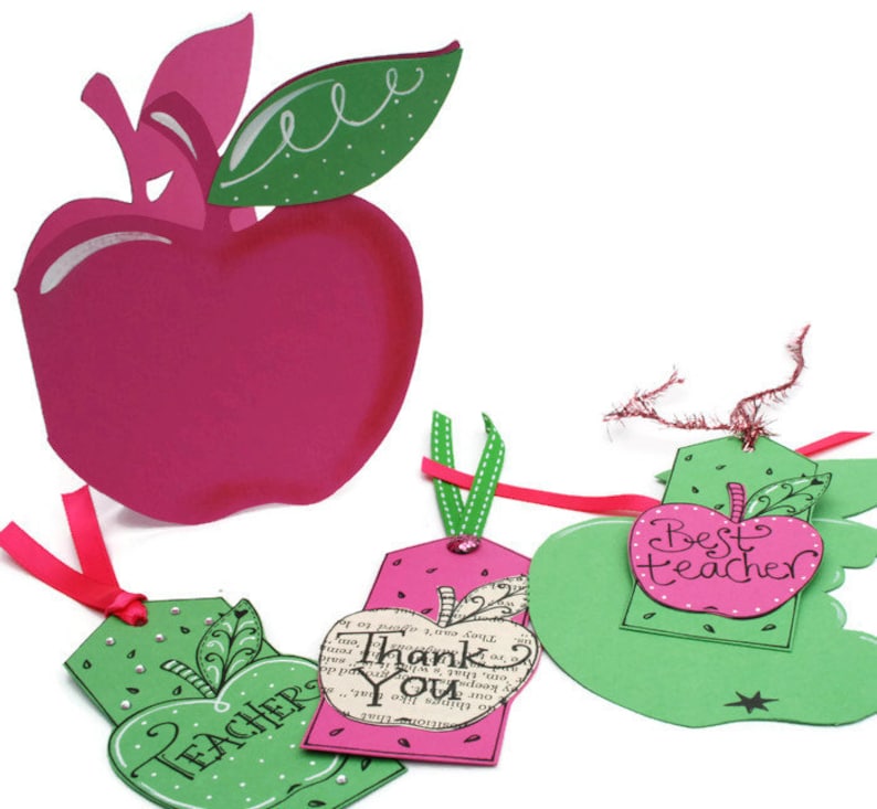 May include: Three green apple-shaped gift tags with pink accents. The tags have different messages: "Teacher", "Thank You", and "Best Teacher".