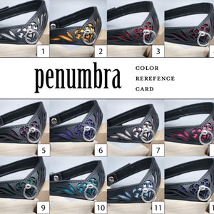 May include: Colour reference card for a leather collar with a decorative cut-out design. The collar is available in 12 different colours, including white, yellow, red, pink, purple, blue, green, and black.