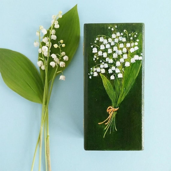 Hand-painted lily of the valley on a wooden keepsake box — delicate botanical art you'd actually display on a dresser.