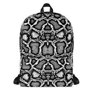 Puede incluir: Mochila con estampado de piel de serpiente en blanco y negro. La mochila tiene una cremallera negra y correas ajustables.