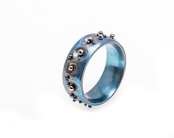 Asteroid belt. Titanium Textured Ring. Hypoallergenic. Welding. Anodizing. Made in Finland.