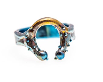 SunnyBlue. Horseshoe Ring. Titanium Welded Ring. Unique piece. Hypoallergenic. Art Welding. Anodizing. Handcrafted in Finland