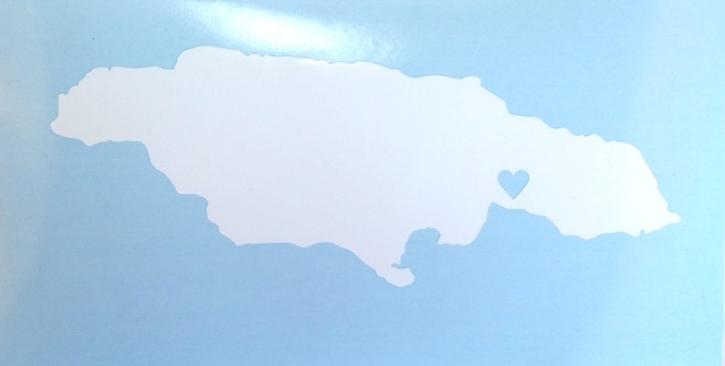 May include: A white outline of the island of Jamaica with a small blue heart in the center.