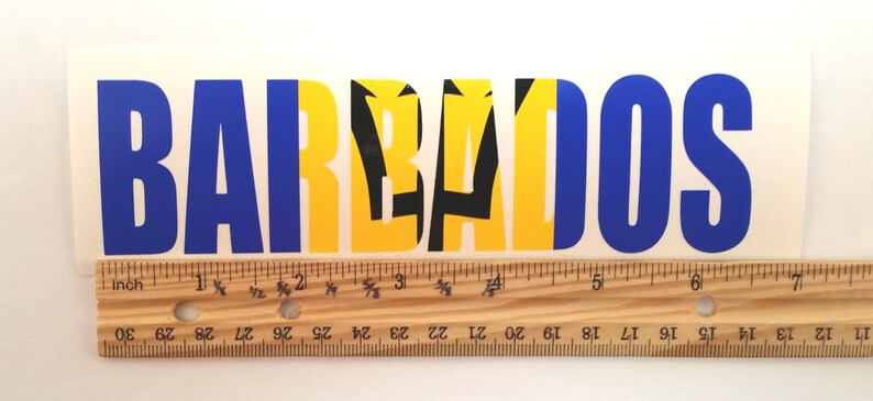 May include: A blue and yellow sticker with the word "BARBADOS" in blue letters and the national flag of Barbados in the center.