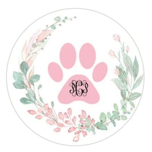 May include: Pink paw print with a floral wreath around it. The paw print has a monogram in the center.