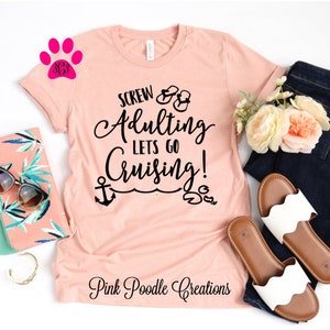 May include: A pink t-shirt with the text "Screw Adulting Lets Go Cruising!" in black. The shirt has a graphic of flip flops, an anchor, and a crab. The text "Pink Poodle Creations" is at the bottom of the shirt.