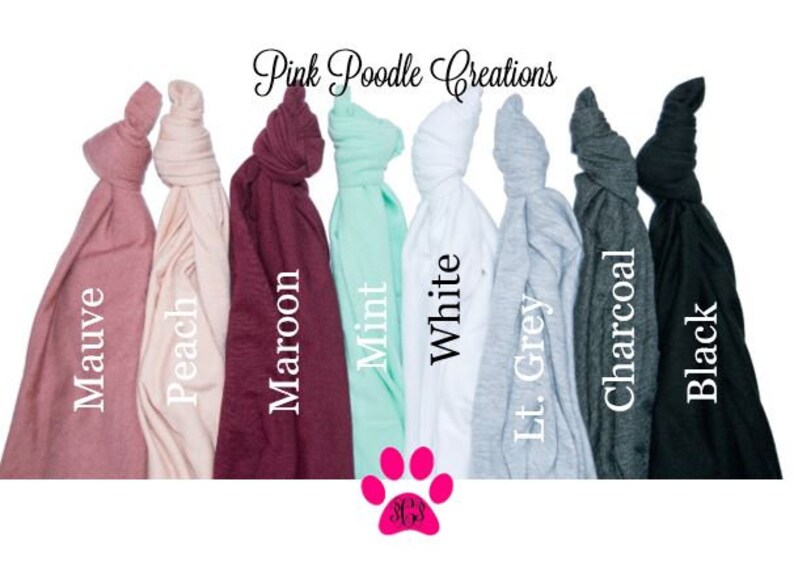 Puede incluir: Una selecci&oacute;n de camisetas de varios colores, incluyendo malva, melocot&oacute;n, granate, menta, blanco, gris claro, carb&oacute;n y negro. Las camisetas est&aacute;n dobladas y dispuestas en fila. Pink Poodle Creations est&aacute; escrito en la parte superior de la imagen.