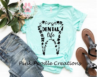 May include: A turquoise t-shirt with a black graphic of a tooth made up of dental tools and the text "DENTAL life".