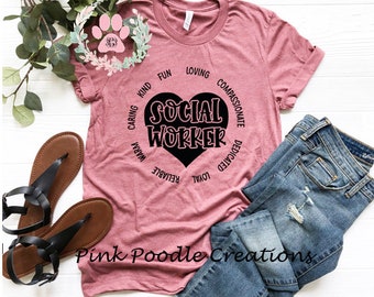 May include: A pink t-shirt with a black heart that says "Social Worker" inside. The heart is surrounded by a circle of words describing the qualities of a social worker, including "caring", "kind", "fun", "loving", "compassionate", "dedicated", "loyal", "reliable", "warm", and "valuable".