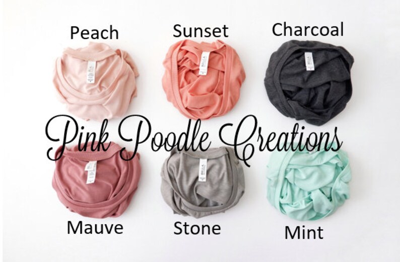 May include: Six folded t-shirts in different colors: peach, sunset, charcoal, mauve, stone, and mint. The shirts are labeled with the color names and the text "Pink Poodle Creations".