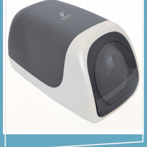 May include: A gray and off-white wall-mounted paper towel dispenser with a rounded, elongated shape. The top surface features the Addison logo in white text. A dark, semi-transparent circular window is positioned on the front face.