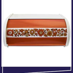 May include: A rectangular bread bin with a roll-top lid featuring a burnt orange finish and a white horizontal band across the centre. The band is decorated with a repeating floral pattern in shades of orange, brown, and white.