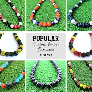 May include: A collection of colourful beaded necklaces with different colour combinations, including black, white, red, blue, yellow, and green. The necklaces are displayed on a green background with the text "POPULAR Custom Order Showcase SLIDE TWO".