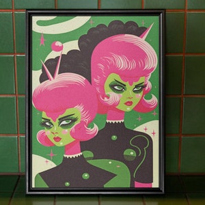 May include: A framed illustration of two women with pink hair and green skin wearing black and green space suits. The background is a green and white swirl pattern.