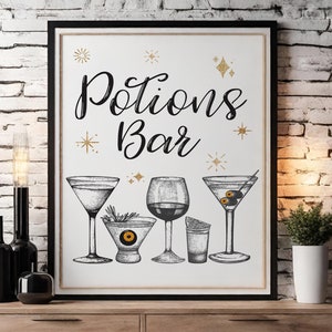 May include: A framed print with the words "Potions Bar" in elegant script, featuring illustrations of various cocktail glasses. Gold star and glitter accents adorn the white background. The print is displayed on a wooden table against a brick wall.