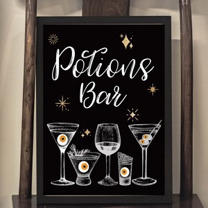 May include: Black chalkboard sign with white text that reads "Potions Bar". The sign is decorated with gold glitter stars and features a hand-drawn illustration of five different cocktails with eyeball ice cubes.