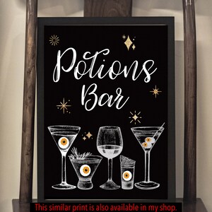 May include: Black framed "Potions Bar" sign with white script and gold star accents. The sign features illustrations of cocktail glasses with eyeball garnishes. A black banner at the bottom reads "This similar print is also available in my shop. It is NOT Included in this listing."