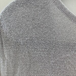 May include: A close-up of a silver knit fabric with a fine, even weave.