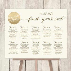 May include: A gold and white wedding seating chart with the text "Amanda & Harry" and "find your seat" on a wooden easel. The chart lists tables with names of guests.