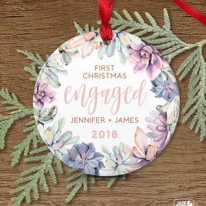 a personalized christmas ornament hanging on a wooden table