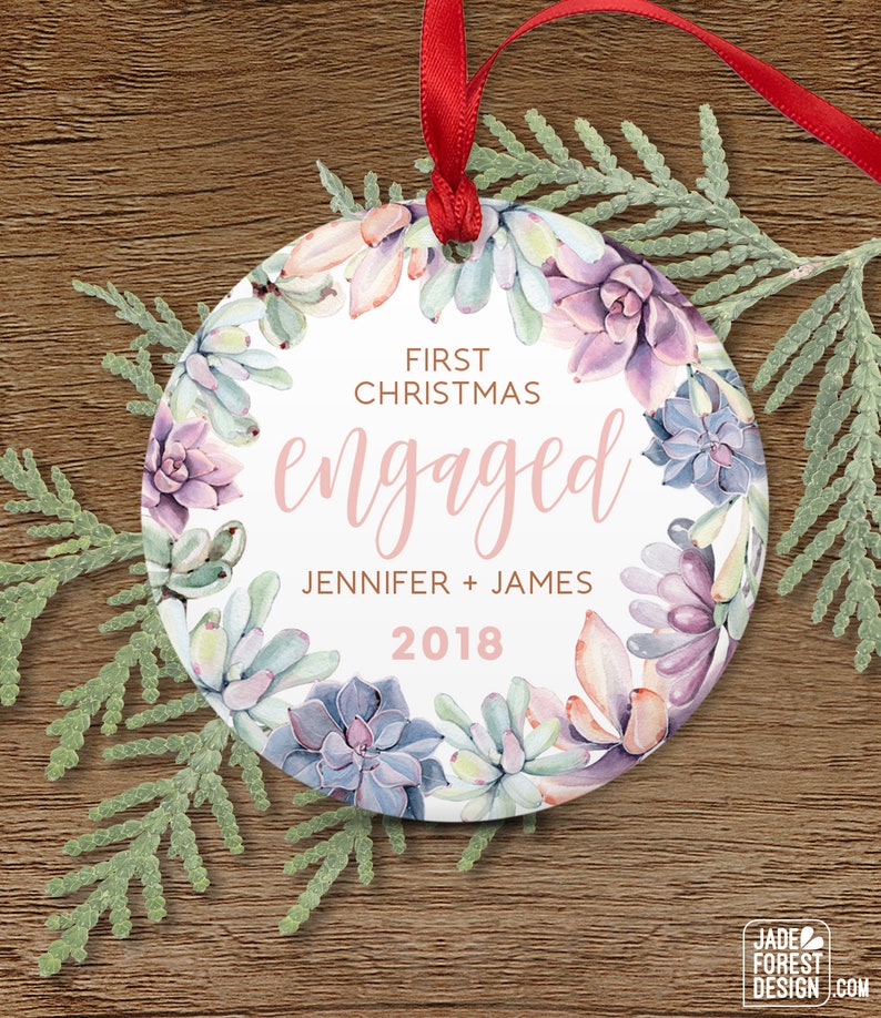 a personalized christmas ornament hanging on a wooden table