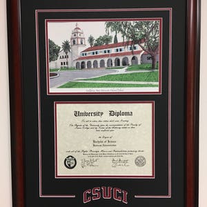 May include: Framed university diploma and watercolor print of a building with a tower. The diploma is for a Bachelor of Science in Business Administration. The frame is dark brown with a black mat and the text "CSUCI" at the bottom.