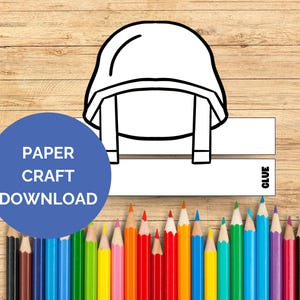 May include: A printable paper craft template of a soldier's helmet. The template is black and white and includes a glue tab. The text "PAPER CRAFT DOWNLOAD" is on a blue circle.