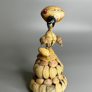 French vintage seashell doll lady in dress holding handbag Fort Mahon beach resort