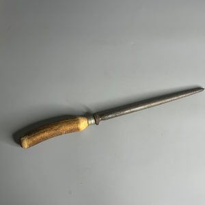 May include: A vintage steel knife sharpener with a brown antler handle. The sharpener is about 12 inches long.