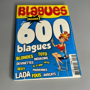 May include: A blue and yellow magazine cover with the title "Blagues 600 blagues" and a cartoon illustration of a woman in a red bikini sitting on a stool. The cover also features a list of categories, including "Blondes", "Toto", "Médecins", "Devinettes", "Sexy", "M. et Mme", "Ch'tis", "Proverbes", "Lada", "Fous", and "Avocats".