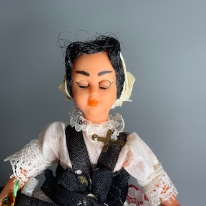 French vintage sleeping doll women in regional dress design celluloid body