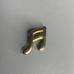 French vintage lapel pin musical note design or initial A atlas