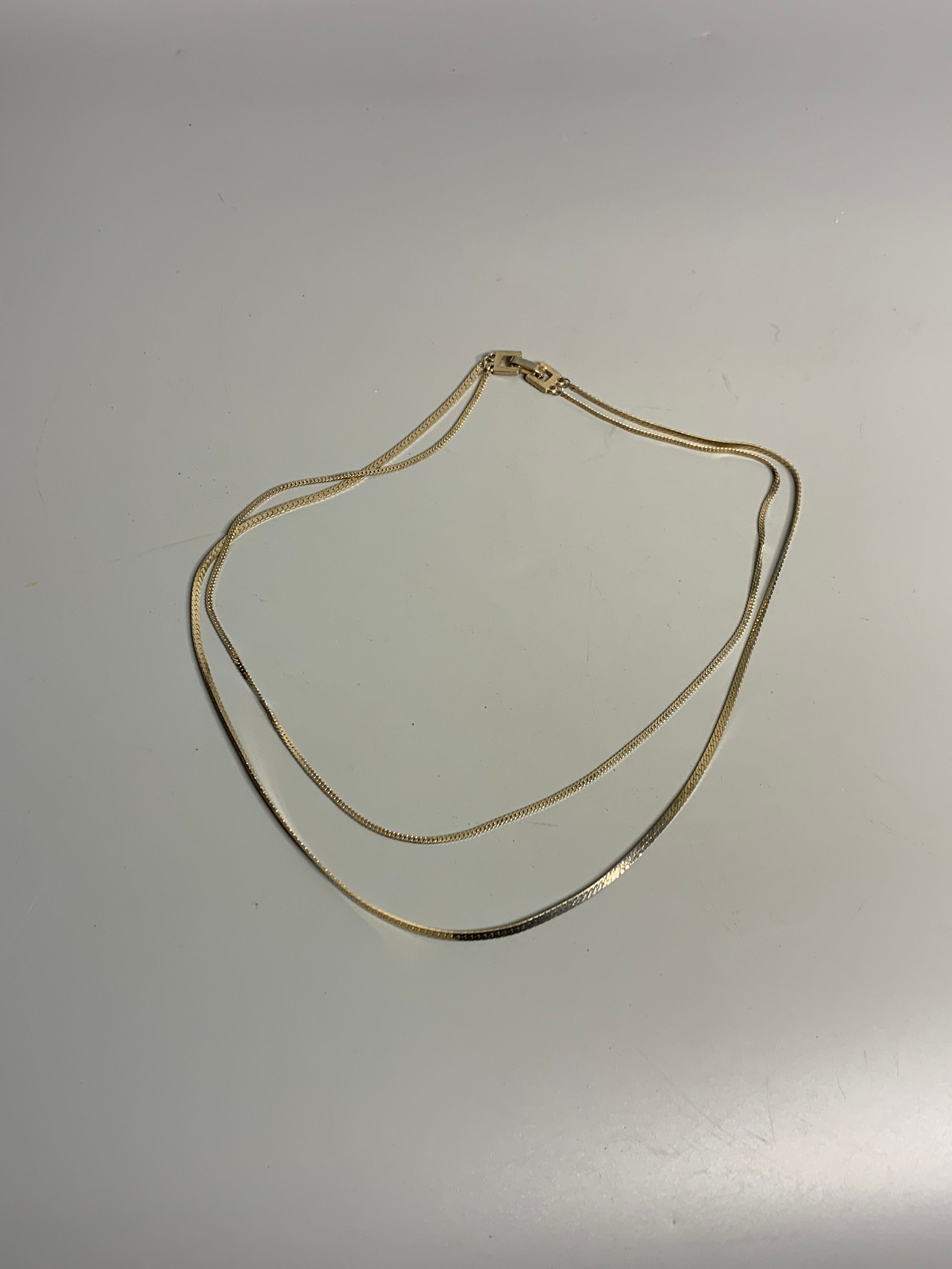 YVES SAINT LAURENT - Collier en métal plaqué or à motifs ovales ornés