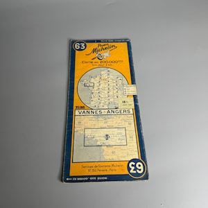 May include: A vintage map of France, titled "Vannes-Angers", from Michelin. The map is printed on yellow paper with blue and black lines. The map is numbered 63 and is part of a series of maps at a scale of 1:200,000. The map shows the cities of Vannes and Angers, as well as the surrounding countryside.