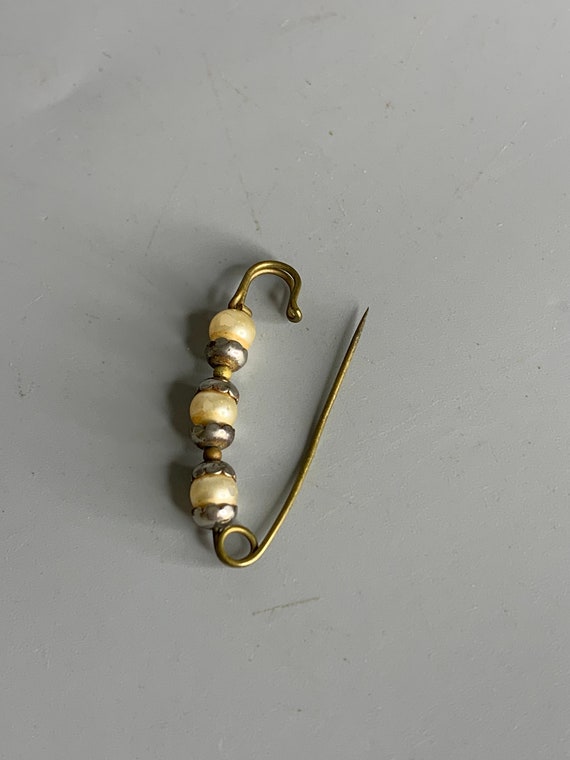 Silver brooch with white stones in safety pin design silver