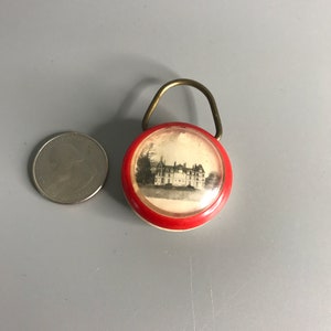 French keychain holder castle with a badge attached